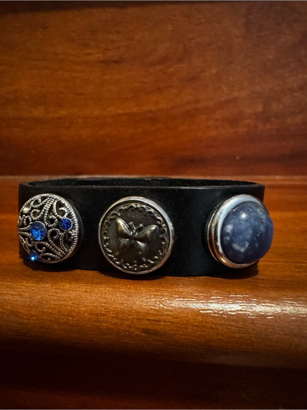 Vintage black leather cuff with blue stone and silver charms